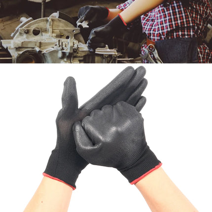 Black gloves with red trim worn by a person working on machinery.