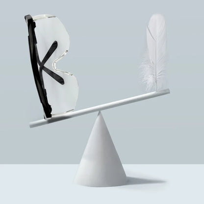 Balancing scale with a shoe and a feather on a light gray background